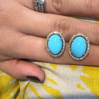 Par de aretes ovalados azules con halo circular brillante